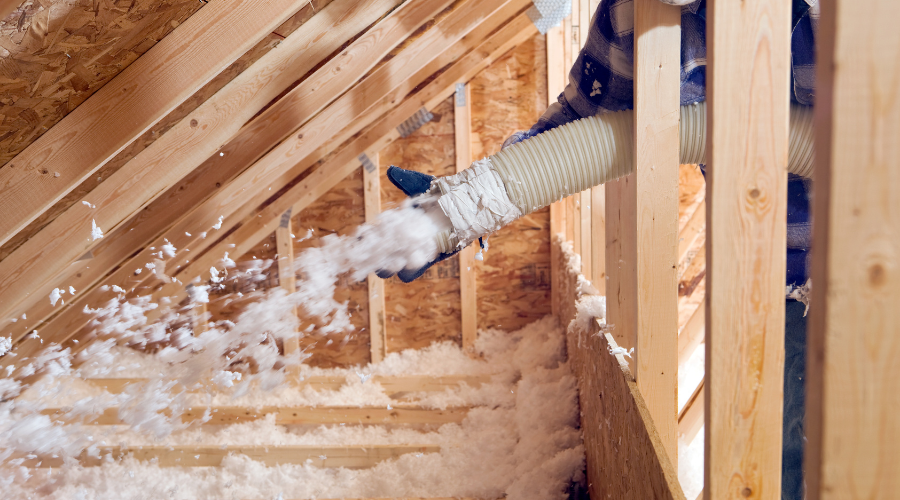Attic insulation installation with blown fiberglass material.