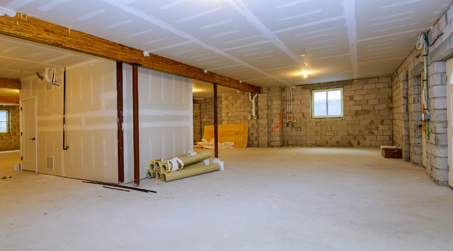 Spacious unfinished basement with concrete walls.