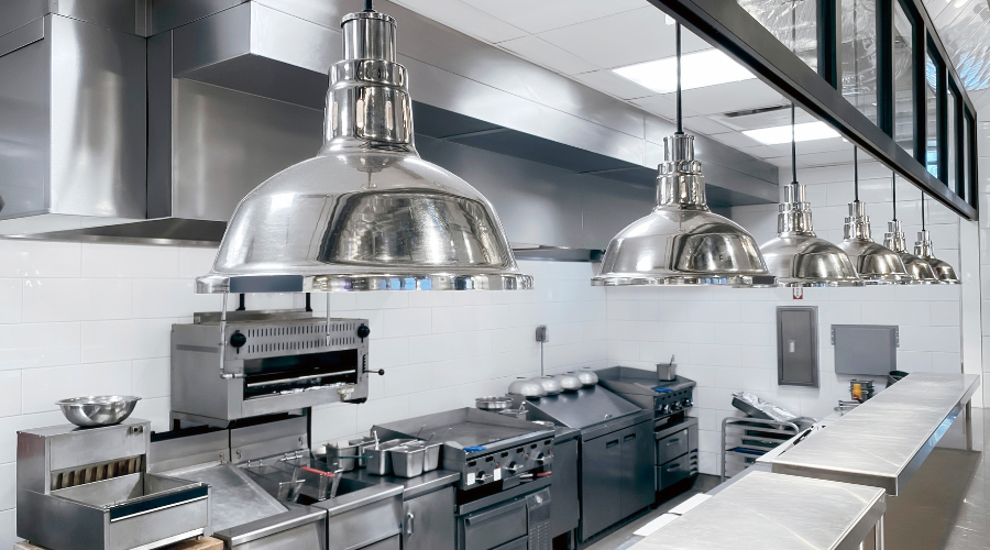Modern industrial kitchen with stainless steel appliances.