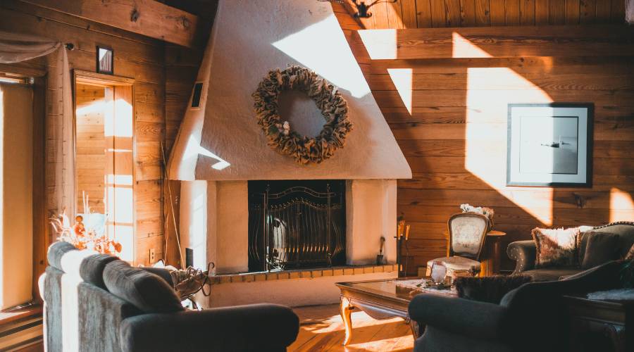 Cozy living room with fireplace and wreath decor.