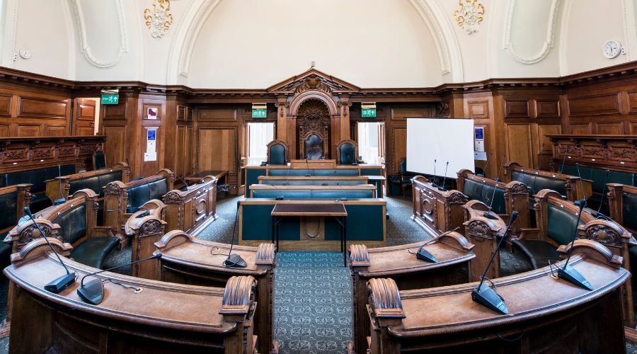 Empty ornate courtroom with wooden furnishings