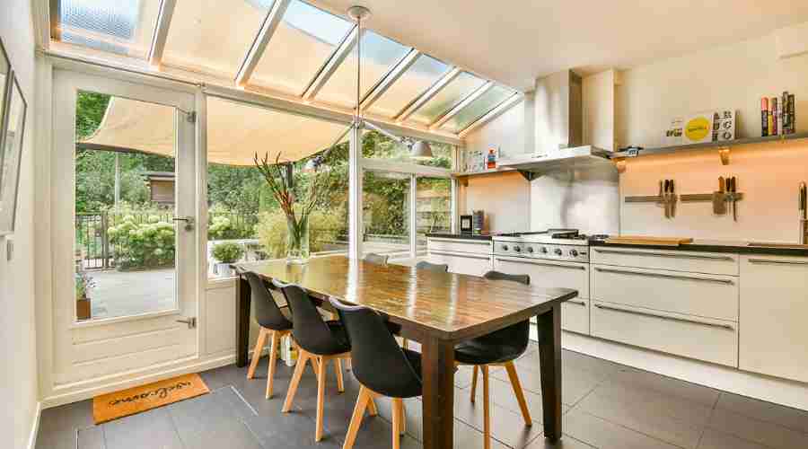 Bright kitchenarea opens to garden with glass roof and modern cookspace showing a sustainable kitchen renovation in Sydney