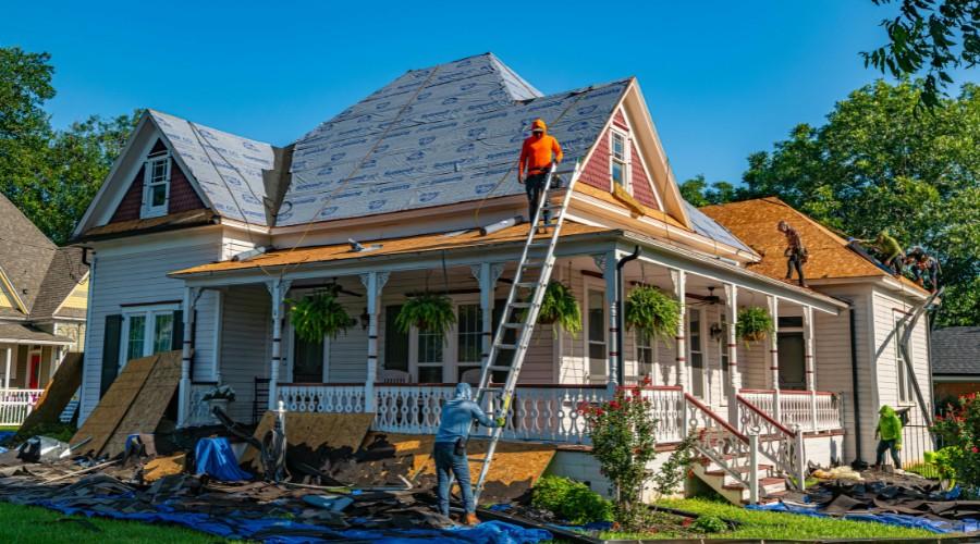 Workers replace the roof of a heritage house as part of a sustainable heritage home renovation Sydney_11zon